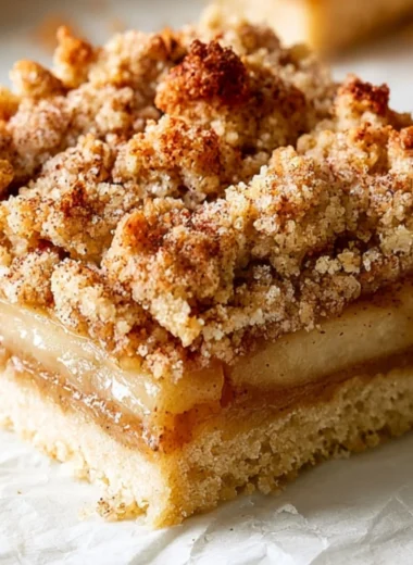 Delicious homemade apple crisp bars topped with a buttery crumble and fresh apples.