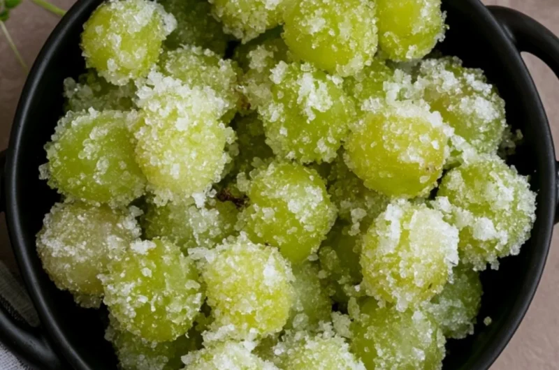 A bowl of candied frozen sour grapes, glistening with sugar crystals.