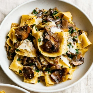 A delicious plate of easy garlic mushroom pasta garnished with fresh herbs