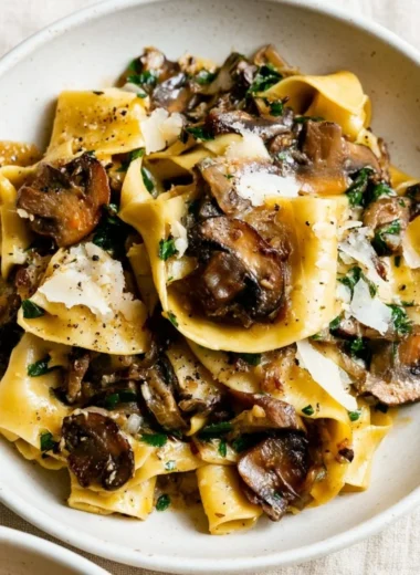 A delicious plate of easy garlic mushroom pasta garnished with fresh herbs
