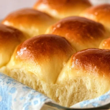 Homemade Grandma's buttery dinner rolls on a serving plate