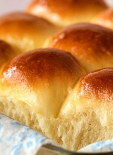 Homemade Grandma's buttery dinner rolls on a serving plate
