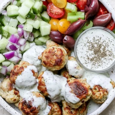 Delicious Greek chicken meatballs served with tzatziki and fresh herbs