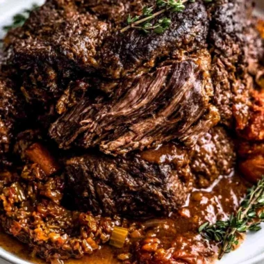 Ina Garten's delicious Company Pot Roast served with vegetables and gravy.