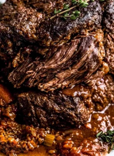 Ina Garten's delicious Company Pot Roast served with vegetables and gravy.