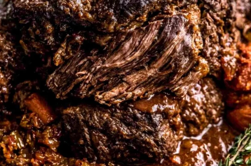 Ina Garten's delicious Company Pot Roast served with vegetables and gravy.