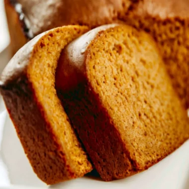 Freshly baked Libby's pumpkin bread with a slice cut out, showcasing its moist texture.