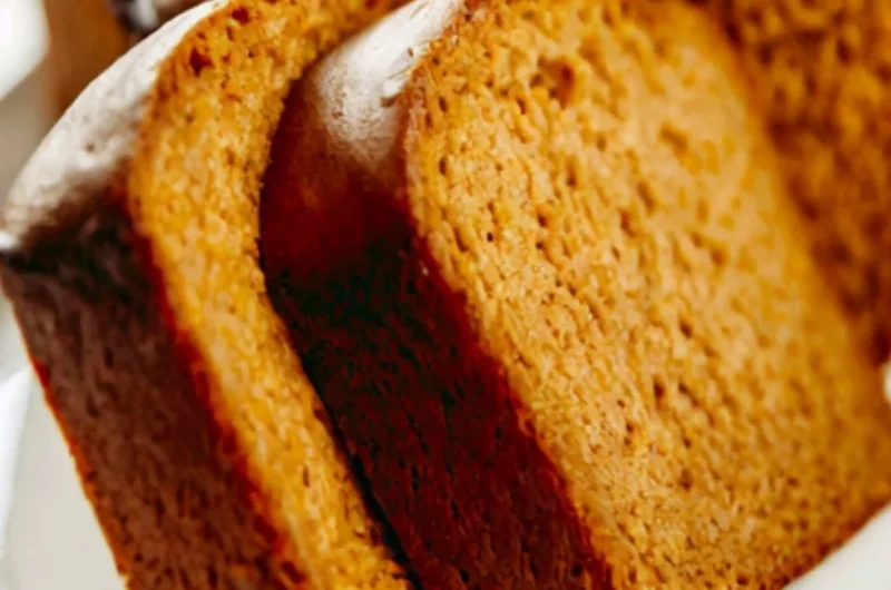 Freshly baked Libby's pumpkin bread with a slice cut out, showcasing its moist texture.