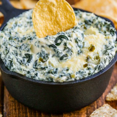 Creamy Spinach Artichoke Dip served in a bowl with fresh vegetables