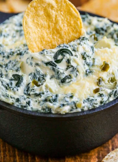 Creamy Spinach Artichoke Dip served in a bowl with fresh vegetables