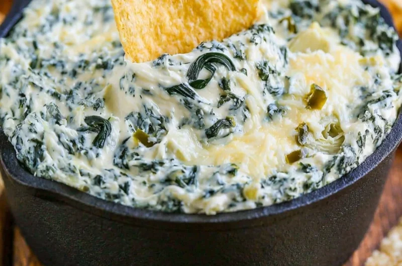 Creamy Spinach Artichoke Dip served in a bowl with fresh vegetables