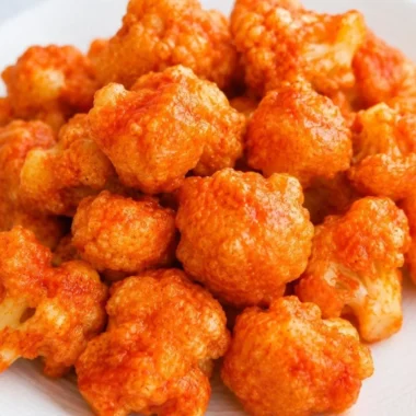 Plate of vegan cauliflower nuggets served with dipping sauce