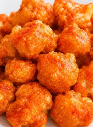 Plate of vegan cauliflower nuggets served with dipping sauce