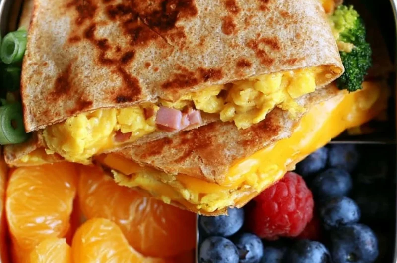 Delicious breakfast quesadilla filled with cheese, eggs, and veggies.