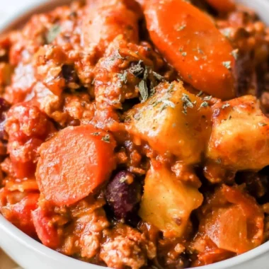 Bowl of Turkey Apple Chili garnished with fresh herbs and spices.