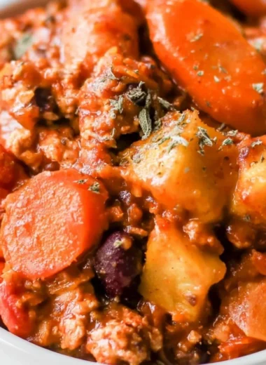 Bowl of Turkey Apple Chili garnished with fresh herbs and spices.