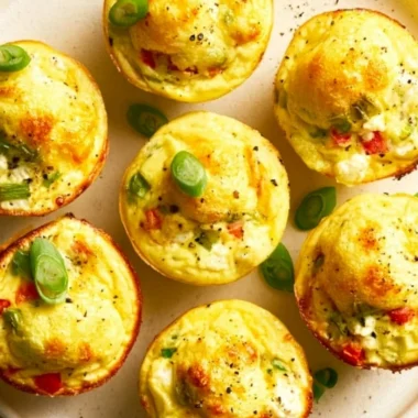 Veggie and egg muffins made with fresh vegetables and eggs, served on a wooden board.