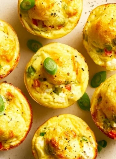 Veggie and egg muffins made with fresh vegetables and eggs, served on a wooden board.