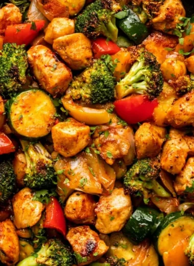 Chicken and vegetables skillet dish served in a frying pan, showcasing vibrant colors.