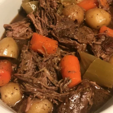 Easy slow cooker pot roast with vegetables in a serving dish