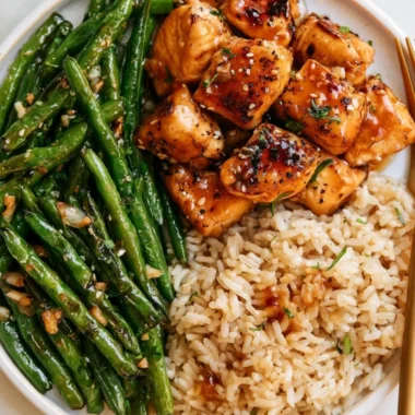 Honey Garlic Chicken served with sautéed green beans, a delicious meal idea.