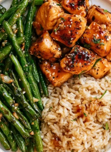 Honey Garlic Chicken served with sautéed green beans, a delicious meal idea.