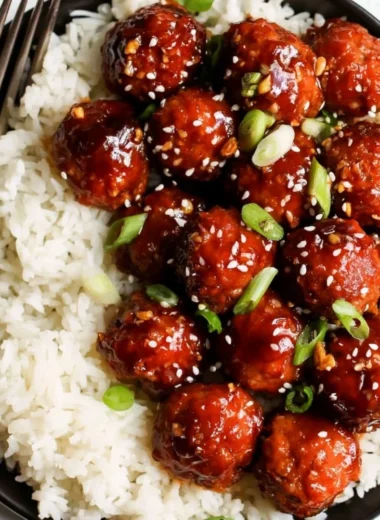 Delicious Honey Garlic Meatballs served with a glaze and garnished with green onions