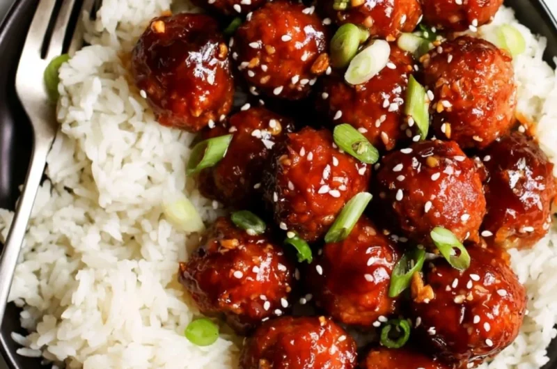 Delicious Honey Garlic Meatballs served with a glaze and garnished with green onions