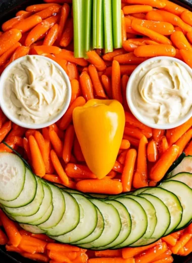 Festive Jack-O-Lantern Veggie Tray with assorted vegetables for Halloween