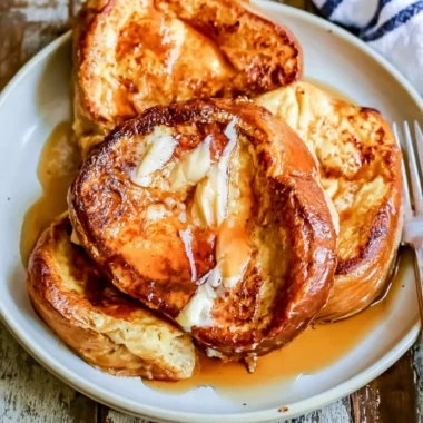 Delicious slice of French toast topped with syrup and berries