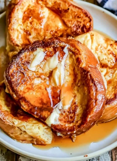 Delicious slice of French toast topped with syrup and berries