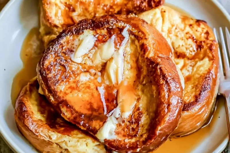 Delicious slice of French toast topped with syrup and berries