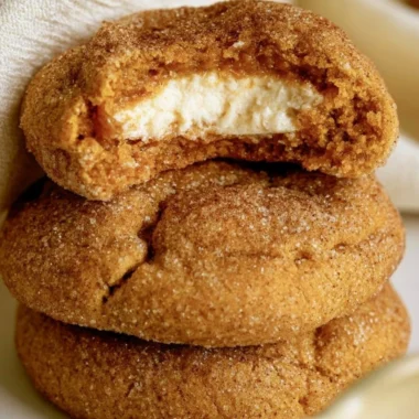 Chewy pumpkin cheesecake cookies on a platter, perfect for autumn baking.