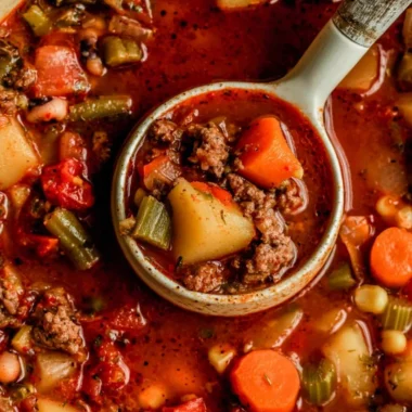 A bowl of Cowboy Soup filled with beans, beef, and vegetables