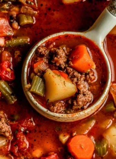 A bowl of Cowboy Soup filled with beans, beef, and vegetables