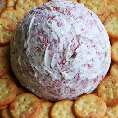 Easy party cheese ball served on a platter with crackers and vegetables