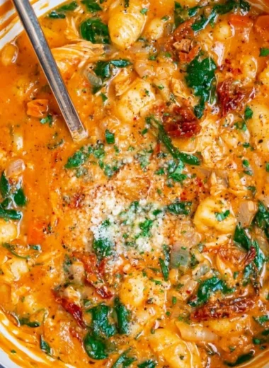 Bowl of Italian Chicken Gnocchi Soup with fresh herbs and vegetables