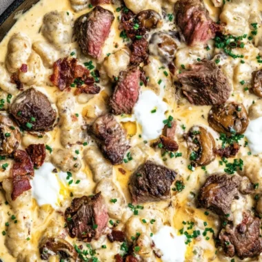 Loaded steak and gnocchi skillet dish served in a pan