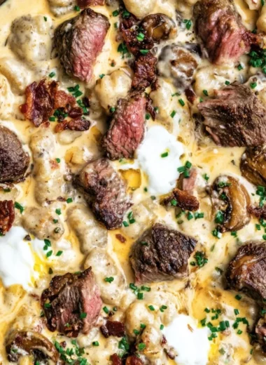 Loaded steak and gnocchi skillet dish served in a pan
