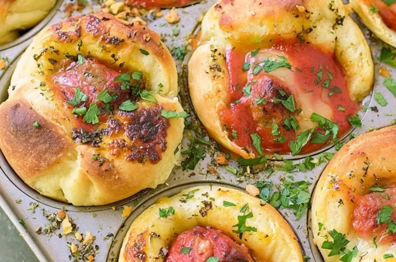 Meatball stuffed garlic bread served on a platter, topped with herbs.