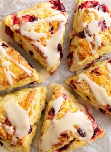Freshly baked cranberry orange scones with cranberries and orange zest.