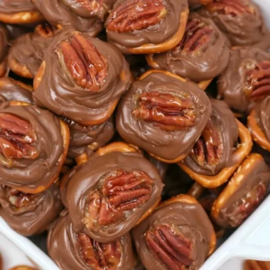 Easy and delicious Rolo Pretzel Bites topped with melted chocolate.