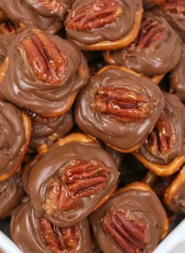 Easy and delicious Rolo Pretzel Bites topped with melted chocolate.
