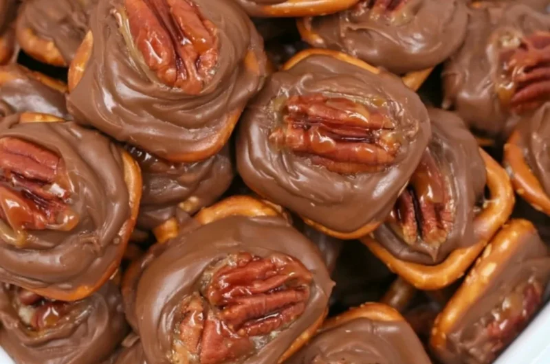 Easy and delicious Rolo Pretzel Bites topped with melted chocolate.